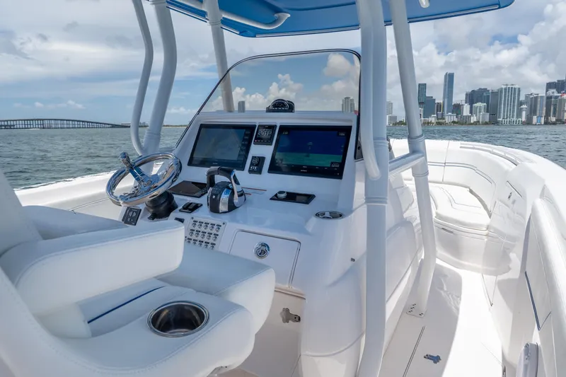 Slide: The Image of Intrepid 345 Nomad FE 2021 boat interior with city skyline in background. - 32