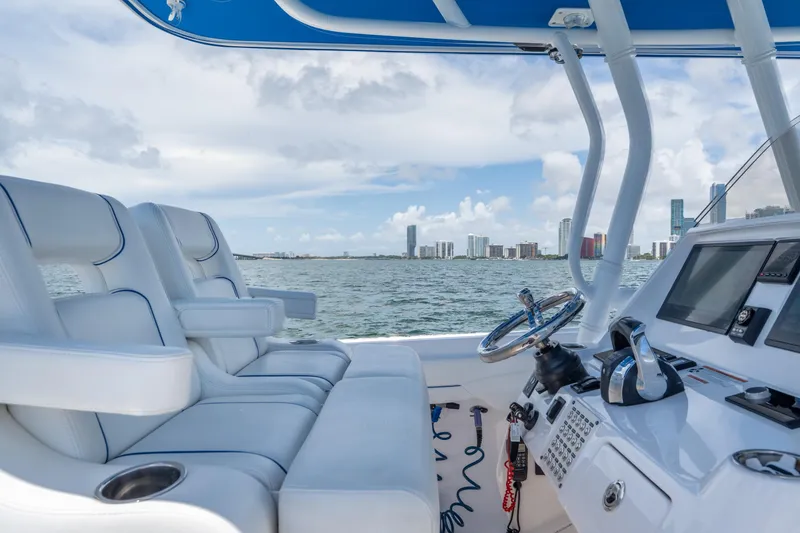 Slide: The Image of 2021 Intrepid 345 Nomad FE boat interior with city skyline in the background. - 34