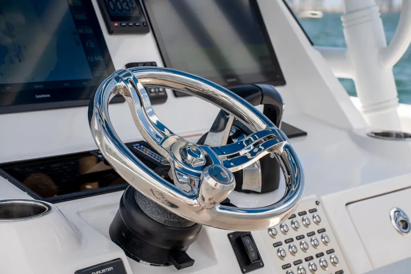 Slide: The Image of Steering wheel of 2021 Intrepid 345 Nomad FE boat with navigation screens. - 35