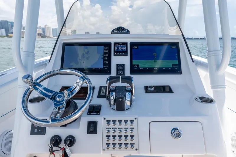 Slide: The Image of 2021 Intrepid 345 Nomad FE helm with advanced navigation displays and controls. - 36