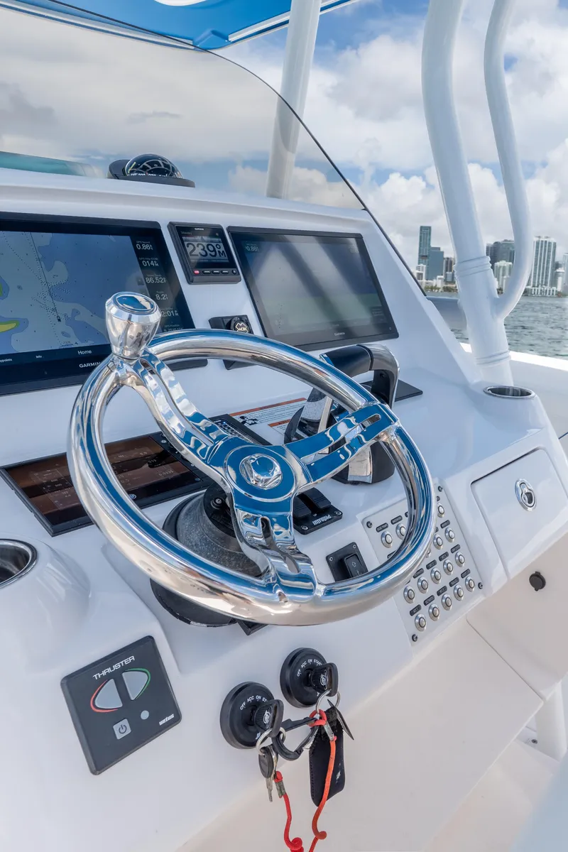 Slide: The Image of Steering console of 2021 Intrepid 345 Nomad FE boat with navigation screens. - 37