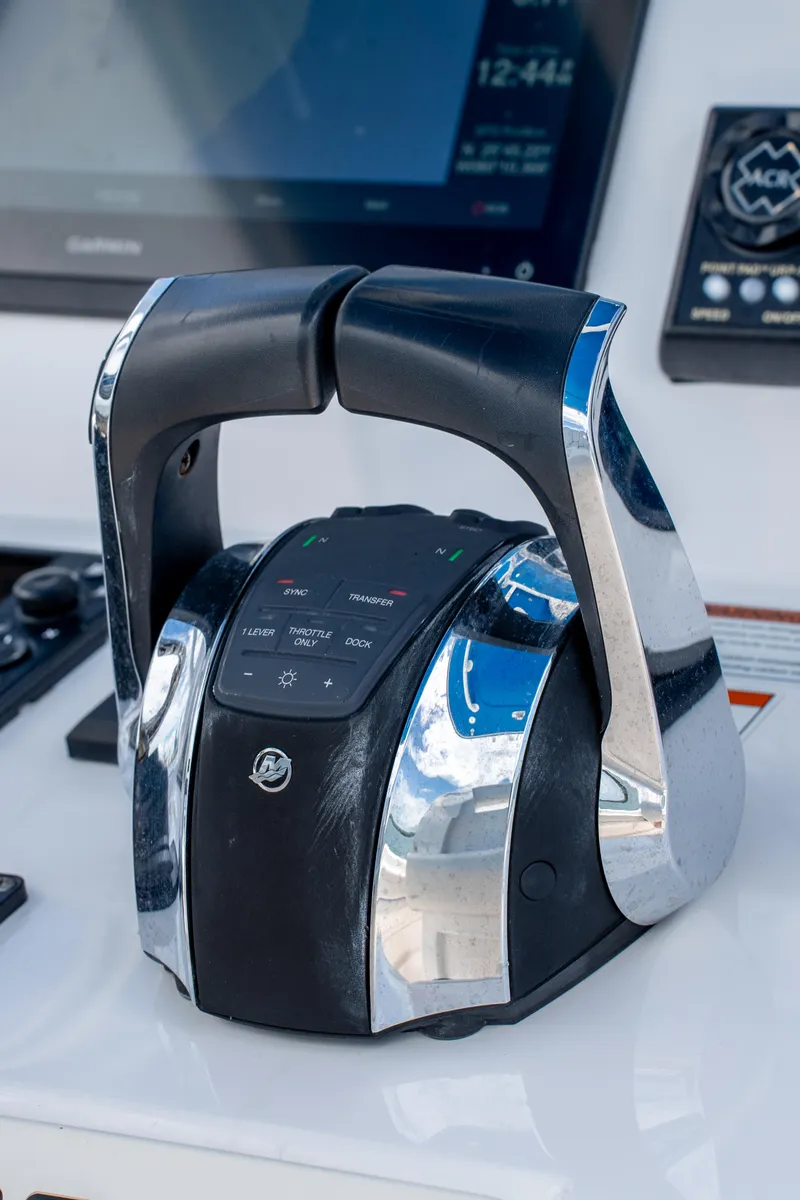 Slide: The Image of Throttle controls on a 2021 Intrepid 345 Nomad FE boat dashboard. - 38
