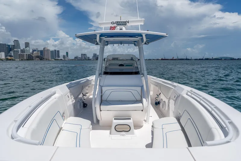 Slide: The Image of 2021 Intrepid 345 Nomad FE boat on water with city skyline in background. - 39