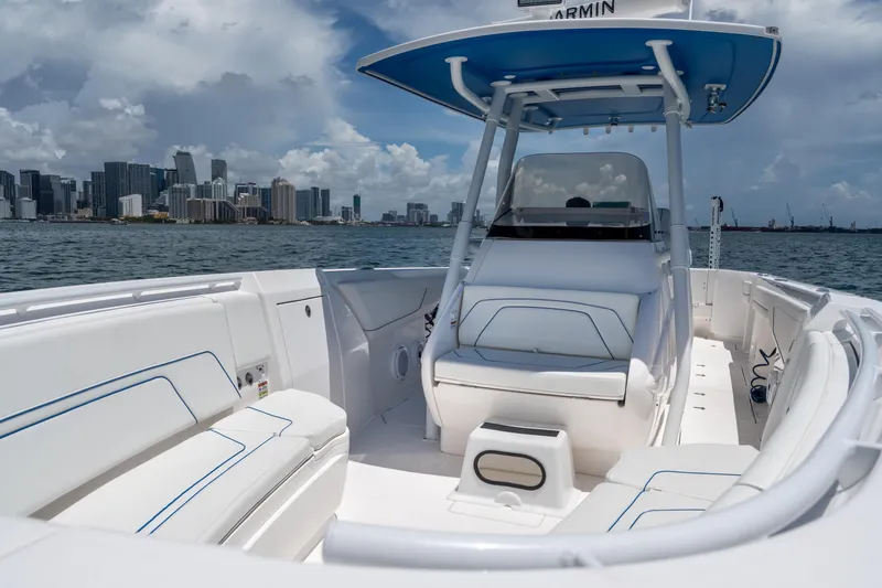 Slide: The Image of 2021 Intrepid 345 Nomad FE boat with city skyline in the background. - 40