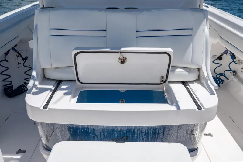 Slide: The Image of 2021 Intrepid 345 Nomad FE boat with open storage compartment on deck. - 42