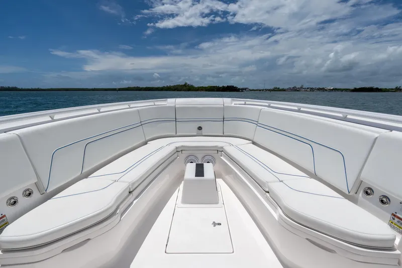 Slide: The Image of 2021 Intrepid 345 Nomad FE boat interior with white seating and ocean view. - 49