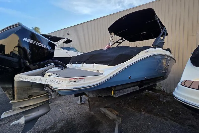 Slide: The Image of 2024 Sea Ray 270 Sundeck boat with cover, displayed outdoors. - 3
