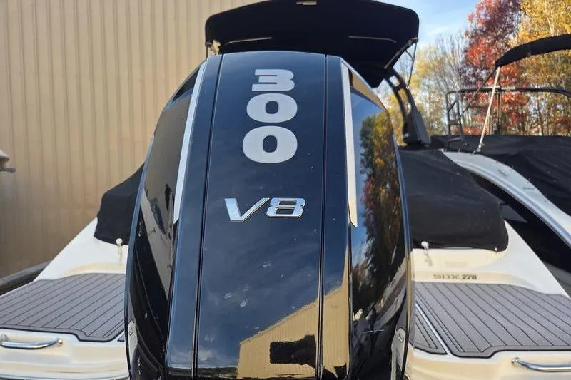 Slide: The Image of 2024 Sea Ray 270 Sundeck with powerful 300 V8 engine, outdoor setting. - 5