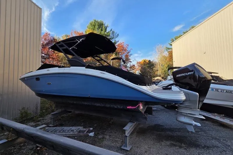 Slide: The Image of 2024 Sea Ray 270 Sundeck boat with Mercury engine, parked outdoors. - 7