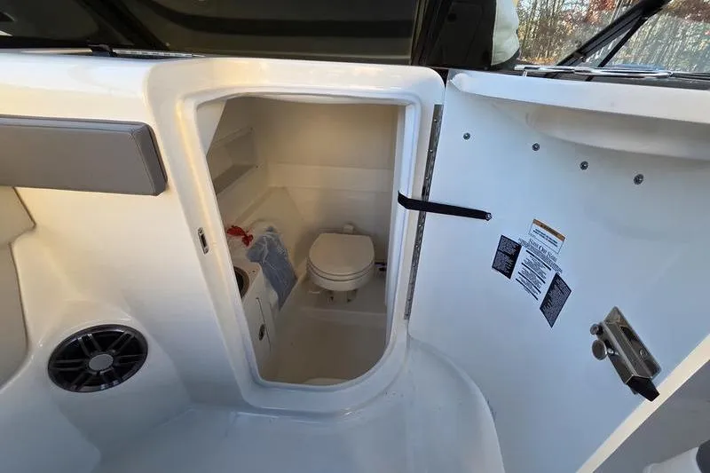 Slide: The Image of 2024 Sea Ray 270 Sundeck boat interior with compact bathroom and toilet. - 8