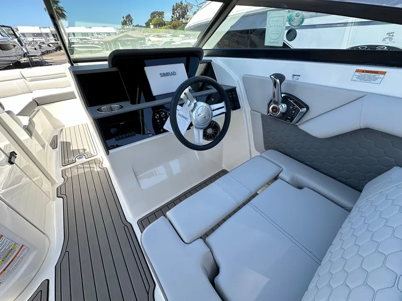 Slide: The Image of 2024 Sea Ray SDX 270 Outboard cockpit with modern steering and seating. - 14