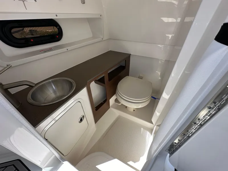 Slide: The Image of 2024 Sea Ray SDX 270 Outboard boat interior with sink and toilet. - 17