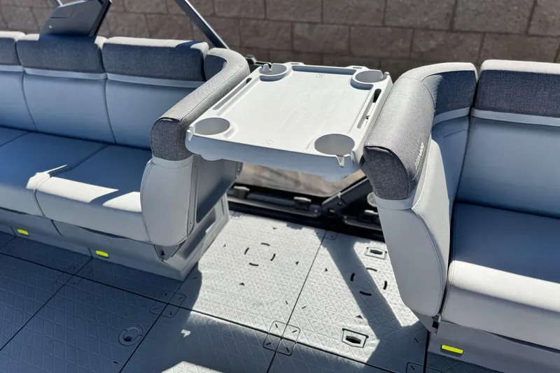 Slide: The Image of 2023 Sea-Doo Switch Cruise 21 interior with foldable table and cushioned seating. - 17