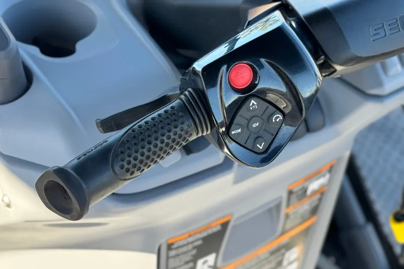 Slide: The Image of Close-up of 2023 Sea-Doo Switch Cruise 21 handlebar controls with start button and mode settings. - 26