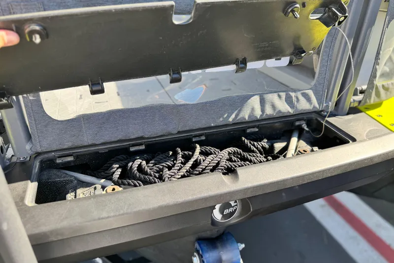 Slide: The Image of Storage compartment of 2023 Sea-Doo Switch Cruise 21, containing coiled ropes. - 4