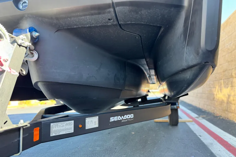 Slide: The Image of 2023 Sea-Doo Switch Cruise 21 on trailer, close-up view of hull and branding. - 5