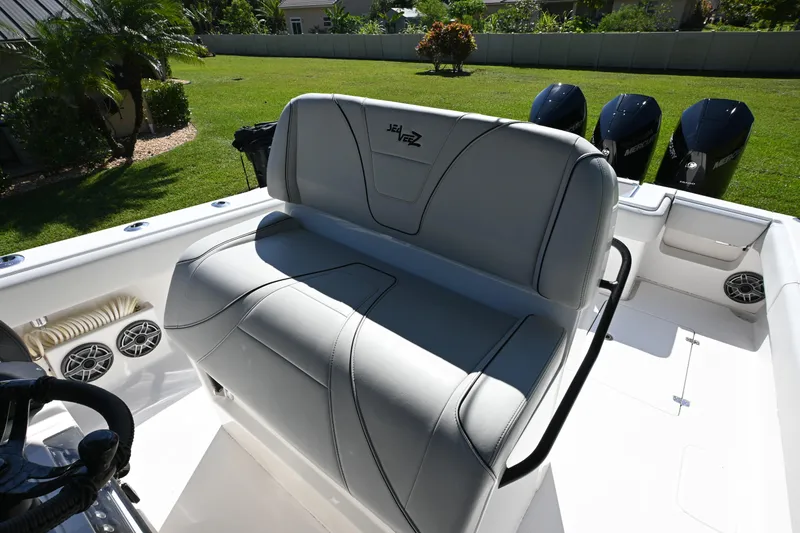 Slide: The Image of 2024 SeaVee 340Z boat interior with cushioned seating and triple Mercury engines. - 16