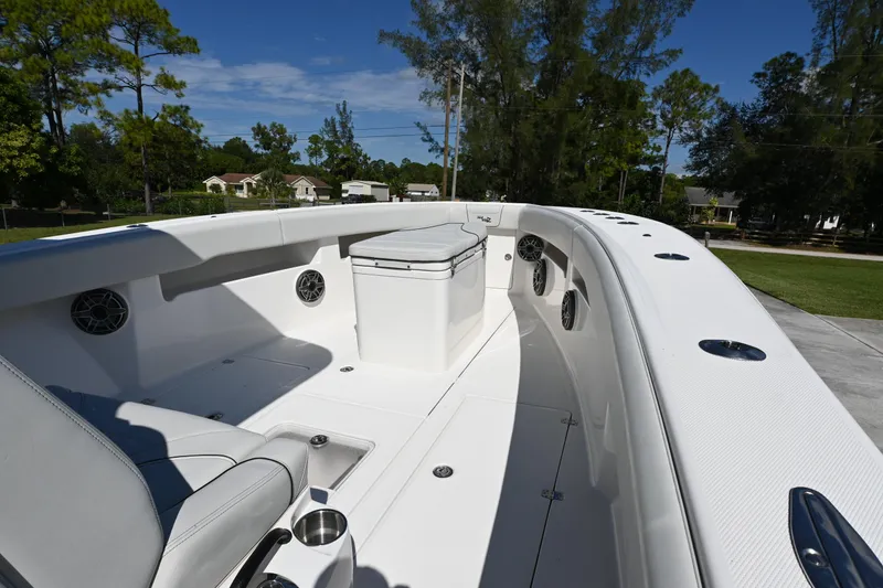 Slide: The Image of 2024 SeaVee 340Z boat interior with seating and speakers, set outdoors. - 19