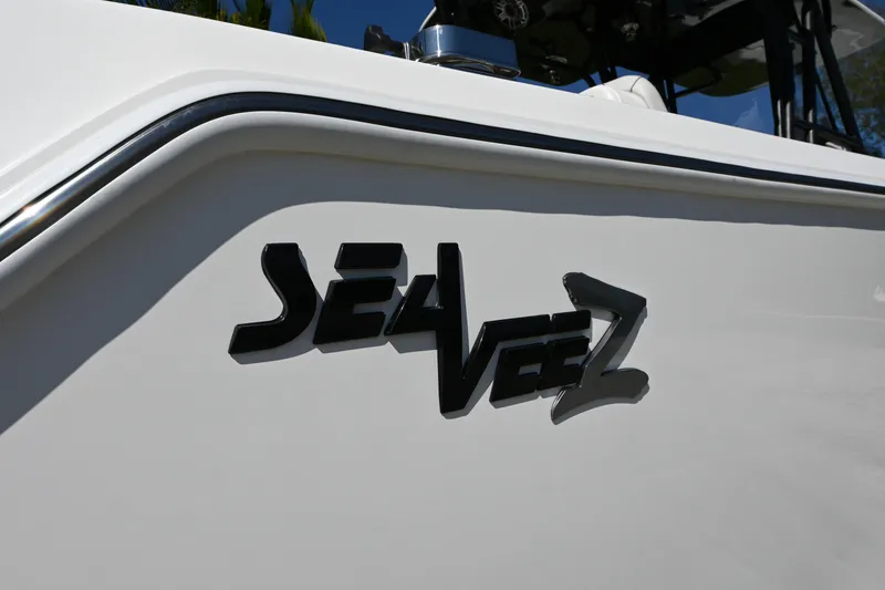 Slide: The Image of 2024 SeaVee 340Z boat logo on white hull, close-up view. - 7