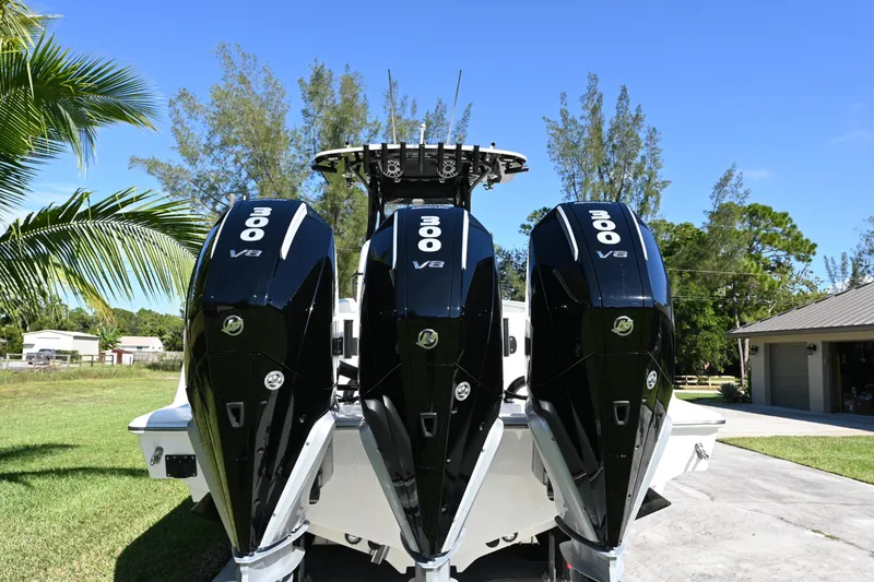 Slide: The Image of 2024 SeaVee 340Z boat with triple 300 V8 engines, parked outdoors. - 8