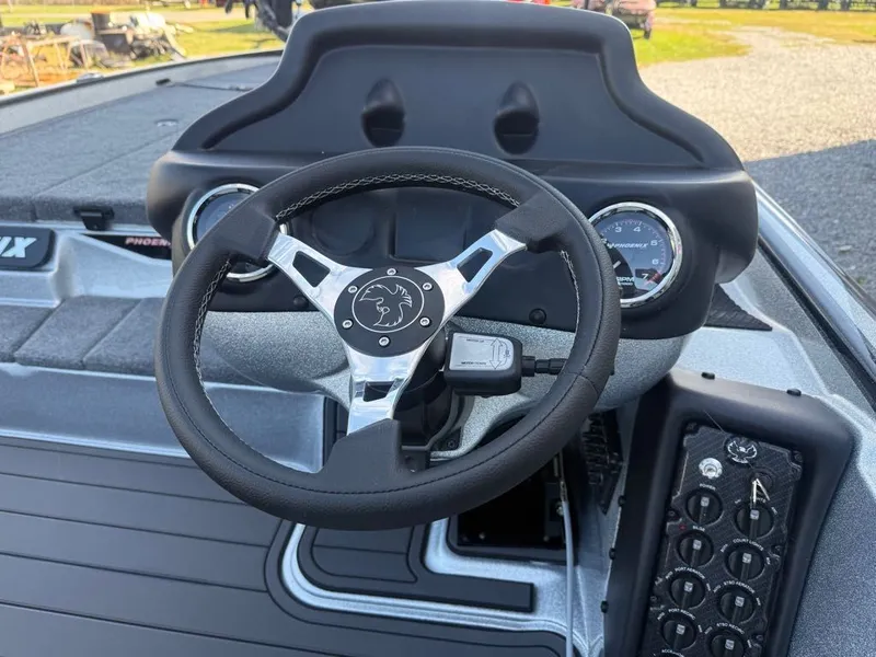 Slide: The Image of Steering wheel and dashboard of 2026 Phoenix 721 ZXL boat, featuring modern controls and gauges. - 3