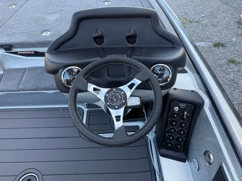 Slide: The Image of Steering console of 2026 Phoenix 721 ZXL boat with gauges and controls. - 7