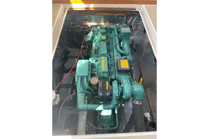 Slide: The Image of Engine compartment of a 1988 Cape Dory Hardtop boat, showcasing a green marine engine. - 11