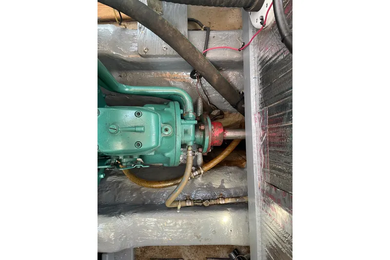 Slide: The Image of Engine compartment of a 1988 Cape Dory Hardtop boat, showing mechanical components. - 14