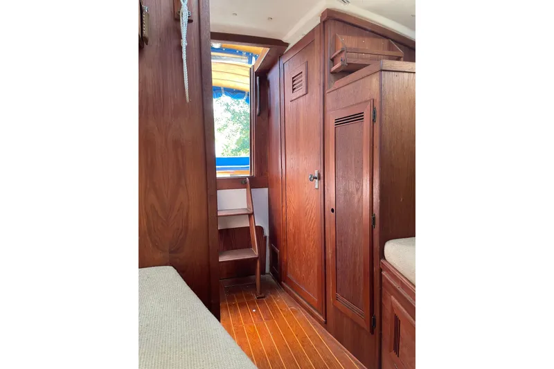Slide: The Image of 1988 Cape Dory Hardtop interior with wooden cabinetry and steps leading to deck. - 25