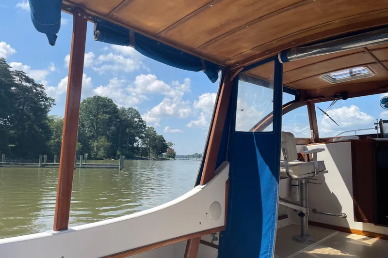 Slide: The Image of 1988 Cape Dory Hardtop boat interior with scenic river view and blue sky. - 9