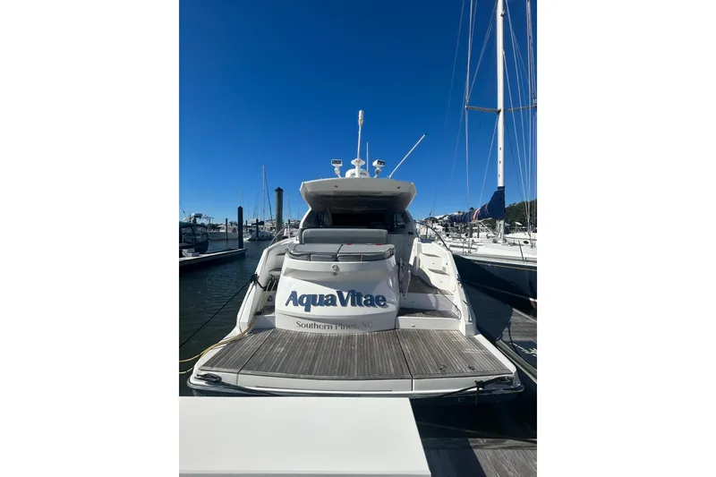 Slide: The Image of 2012 Beneteau Gran Turismo 44 yacht docked at marina under clear blue sky. - 2