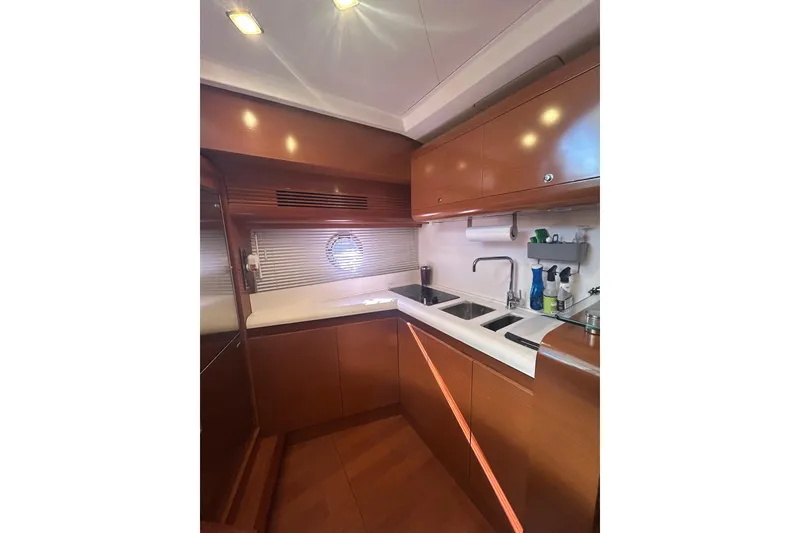 Slide: The Image of Interior of 2012 Beneteau Gran Turismo 44 yacht kitchen with wooden cabinetry and modern fixtures. - 20