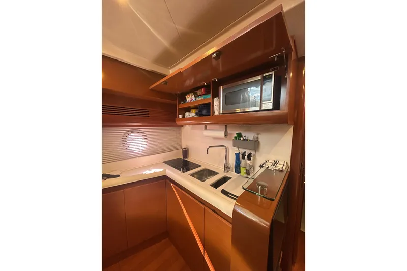 Slide: The Image of Compact kitchen in 2012 Beneteau Gran Turismo 44 yacht with sink, microwave, and storage. - 22
