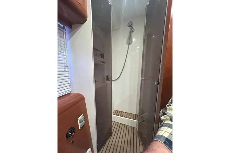 Slide: The Image of Shower area inside 2012 Beneteau Gran Turismo 44 yacht, featuring wooden flooring and modern fixtures. - 27