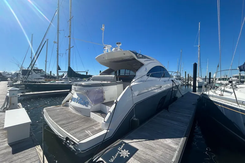 Slide: The Image of 2012 Beneteau Gran Turismo 44 yacht docked at marina under clear blue sky. - 3