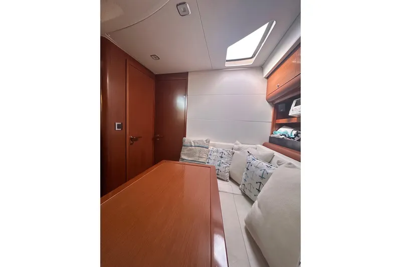 Slide: The Image of Interior of 2012 Beneteau Gran Turismo 44 yacht with cozy seating and wooden finishes. - 41