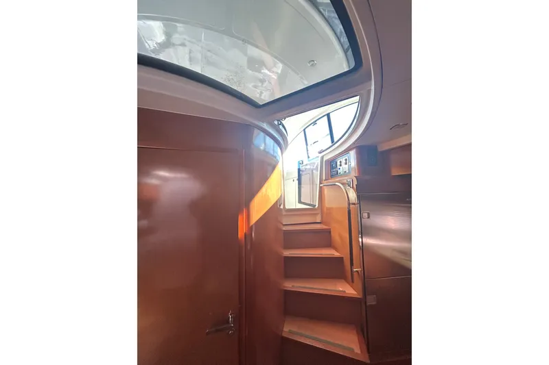 Slide: The Image of Interior staircase of 2012 Beneteau Gran Turismo 44 yacht, featuring wooden steps and modern design. - 42