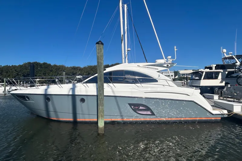 Slide: The Image of 2012 Beneteau Gran Turismo 44 yacht docked in marina under clear blue sky. - 5