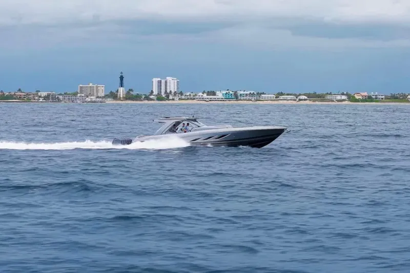 Slide: The Image of 2026 Deep Impact 499 Sport speedboat cruising near coastal cityscape. - 11