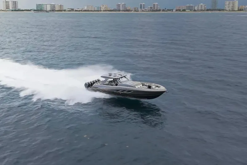 Slide: The Image of 2026 Deep Impact 499 Sport speedboat cruising on open water near a city skyline. - 22