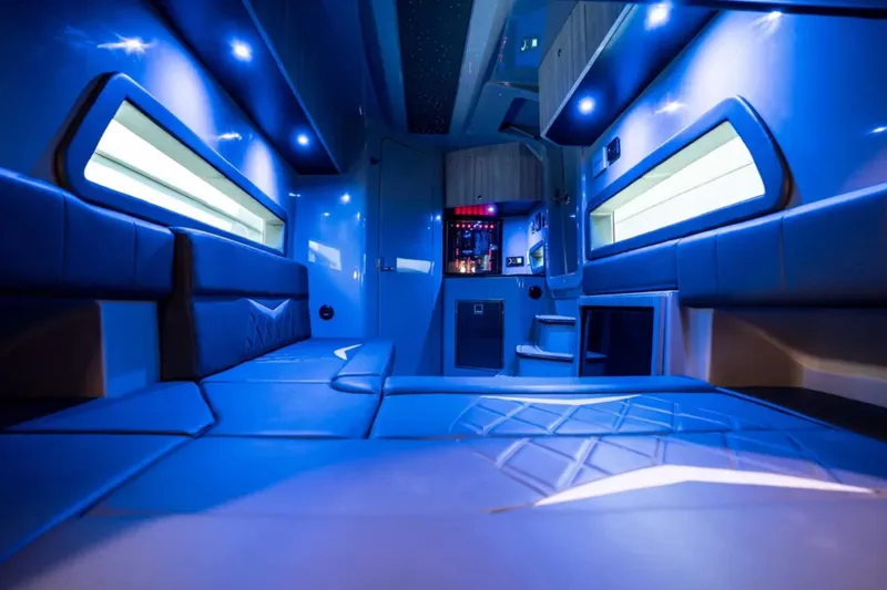 Slide: The Image of Luxurious interior of 2026 Deep Impact 499 Sport boat with blue ambient lighting. - 36