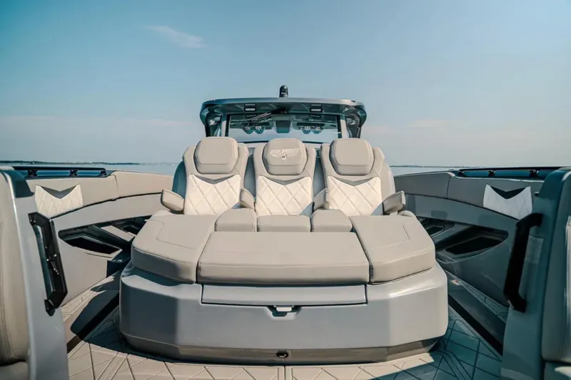 Slide: The Image of Luxurious seating on 2026 Deep Impact 499 Sport boat under clear blue sky. - 37