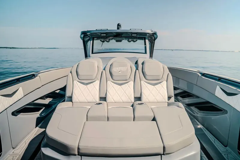 Slide: The Image of 2026 Deep Impact 499 Sport boat interior with luxurious seating on calm water. - 39