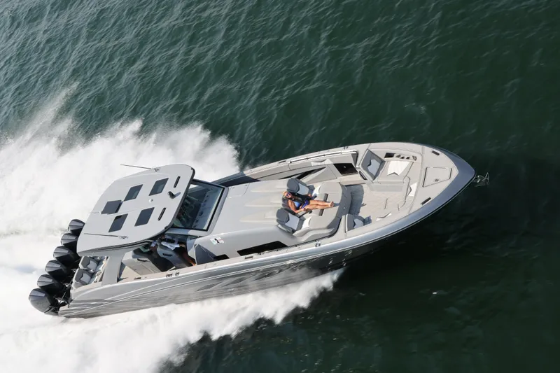 Slide: The Image of 2026 Deep Impact 499 Sport boat speeding on water, showcasing sleek design and powerful engines. - 4