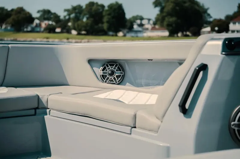 Slide: The Image of Interior of 2026 Deep Impact 499 Sport boat with cushioned seating and speaker. - 44