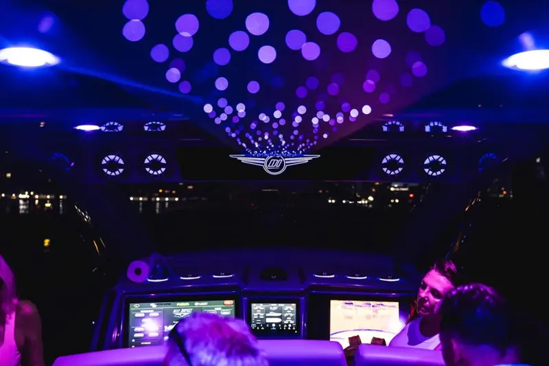 Slide: The Image of Interior of 2026 Deep Impact 499 Sport boat with vibrant purple lighting. - 50