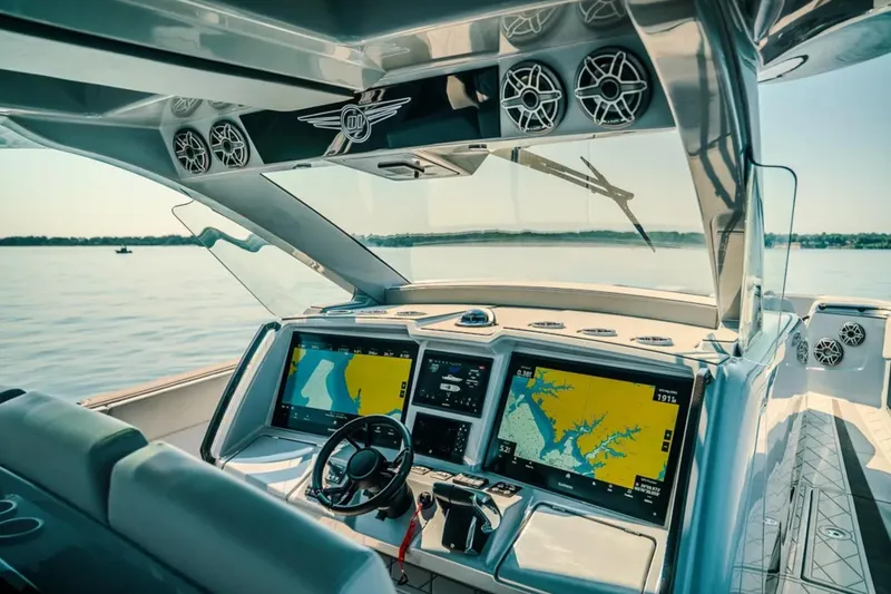 Slide: The Image of Luxury cockpit of 2026 Deep Impact 499 Sport boat with advanced navigation displays. - 52
