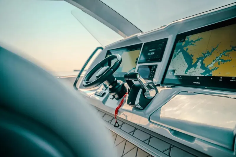 Slide: The Image of 2026 Deep Impact 499 Sport boat dashboard with steering wheel and navigation screens. - 53