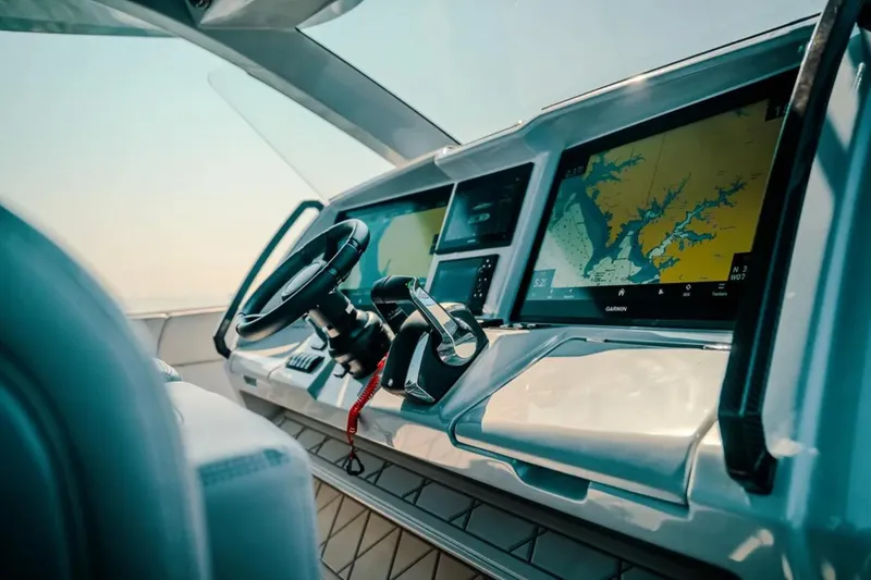 Slide: The Image of Helm of 2026 Deep Impact 499 Sport boat with navigation screens and steering wheel. - 55
