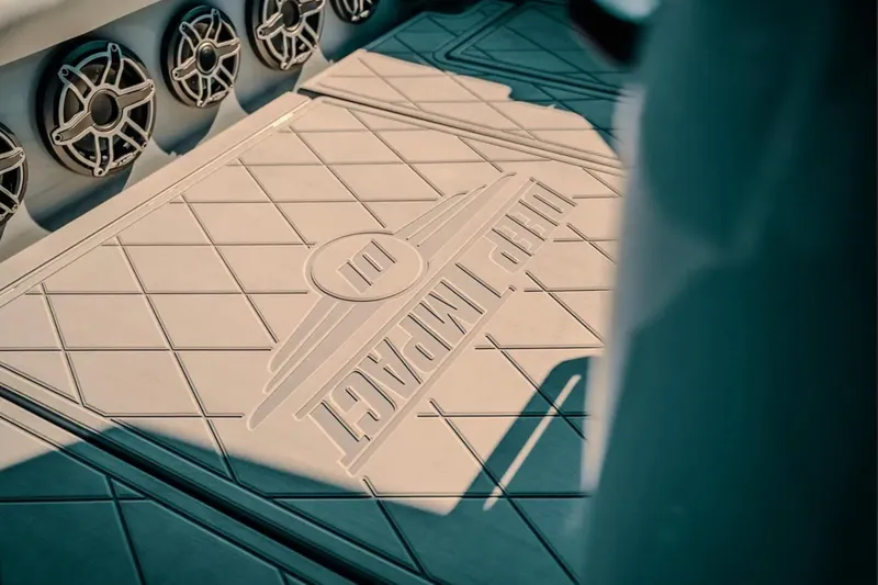 Slide: The Image of Deck of 2026 Deep Impact 499 Sport boat with logo and speakers. - 62